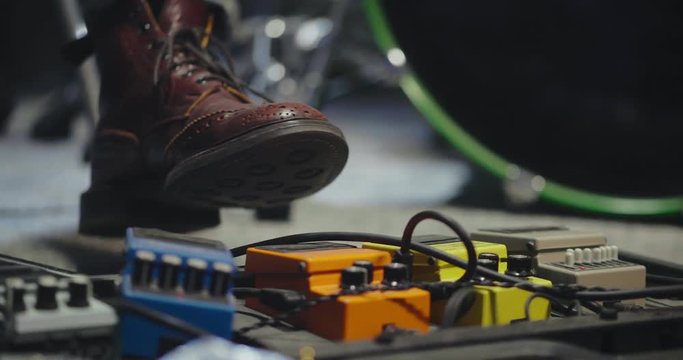 Close up of foot of the guitarist pressing the pedal