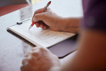Person filling out a medical form