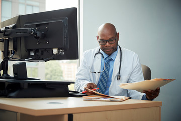 Doctor looking at files