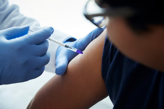 Patient being given an injection by a doctor