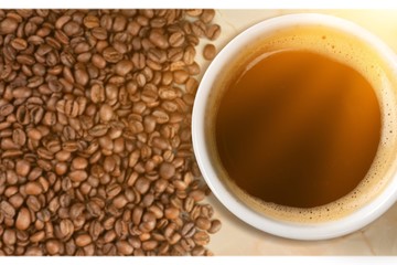 Coffee cup and coffee beans on  background