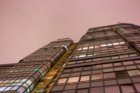 Modern office or residential building in the evening. Viewe from grownd to sky