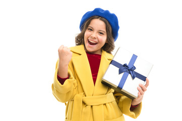Kid little girl in elegant coat curly hairstyle hold gift box. Child excited about unpacking her gift. Small cute girl received holiday gift. Dreams come true. Best birthday and christmas gifts
