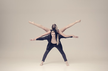 Fototapeta na wymiar acrobat sensual dancers on empty background