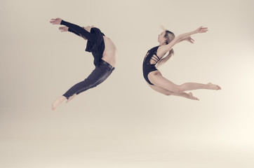 Fototapeta na wymiar acrobat sensual dancers on empty background