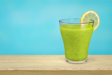 Glass of fresh juice on wooden table