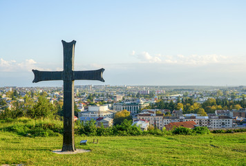 Fototapeta na wymiar big black cross on the city's panoramic background