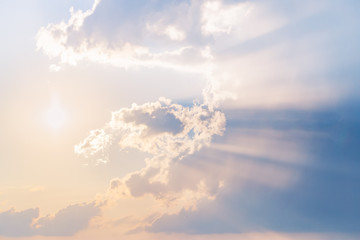 Incredible Sunset Sky with golden sun rays and blue heaven and clouds. Sun shine through the clouds. Beautiful background, backdrop or texture.