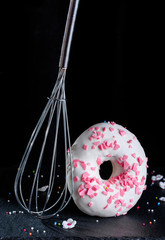 Delicious and flavorful donut with white icing. Donut with icing and dressing. Delicious donut on a...