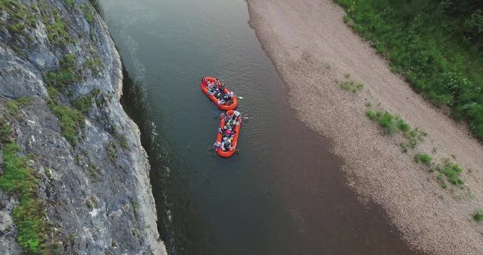 Epic Rafting Two Orange Boat on Shallow Mountain Forest Zilim River in Ural Mountains, Russia at summer sunny day - Aerial view