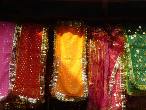 Multi-colored cloth hanging outside a mosque, New Delhi, India