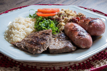 Brazilian food dish - barbecue, rice and beans