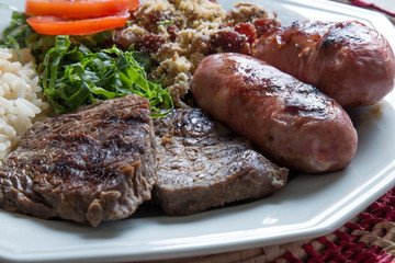 Brazilian food dish - barbecue, rice and beans