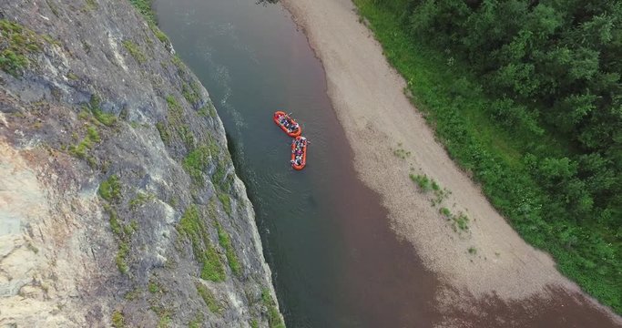 Epic Rafting Two Orange Boat on Shallow Mountain Forest Zilim River in Ural Mountains, Russia at summer sunny day - Aerial view