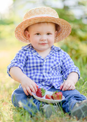 portrait of a Little boy playing in summer nature