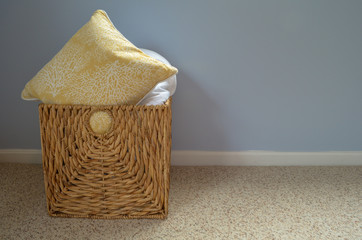 A extra pillow stored in a woven basket