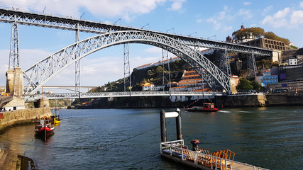 Naklejka premium View of the Dom Luis I Bridge and Douro river from La Ribeira in Porto, Portugal