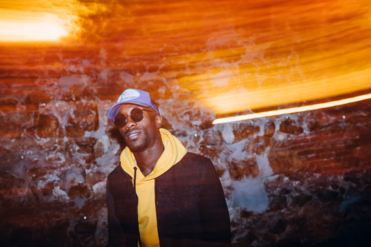 African Man Rapper Among Colorful Light. Long Exposure