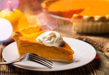 Tasty pumpkin pie on background
