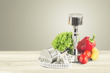 Dumbbells with bottled water , measuring tape