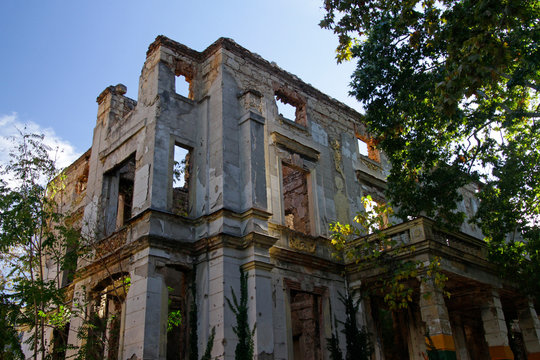 Remains Of The War In Mostar, Bosnia And Herzegovina: Ruin Without A Roof With Trees Growing Inside Of It