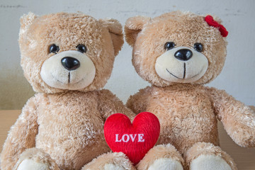 two teddy Bear with Heart on wood table