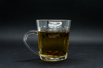 Tea in a glass isolated in black background