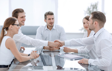 handshake business people at the negotiating table.