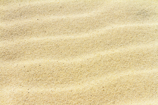 Rippled sand on the sea coast formed by wind and water, background, texture, pattern