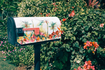Floral mailbox with polynesian flowers as background