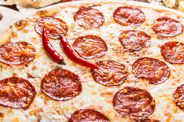 Large spicy pizza with salami and pepperoni sausage. Macro