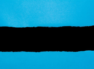 Blue torn paper with opening black space for text. Paper scroll background