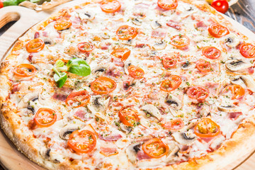 Big pizza with bacon, mushrooms and tomatoes. Macro