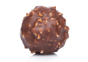 Luxury chocolate candy with hazelnuts and cocoa cream on white background.