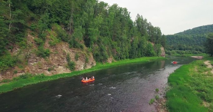 Epic Rafting Two Orange Boat on Shallow Mountain Forest Zilim River in Ural Mountains, Russia at summer sunny day - Aerial view