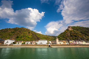 Fototapeta na wymiar View along the beautiful Rhine River in Germany with the Village of Sankt Goar in view