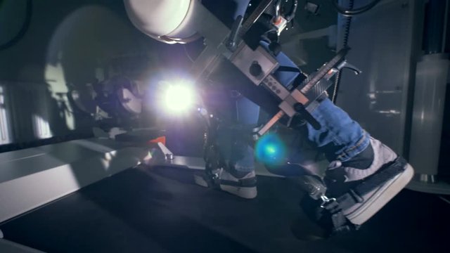 Fixated legs of a physically challenged man training on a walking simulator
