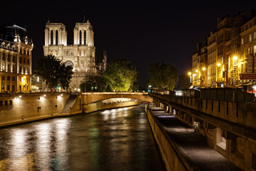 Fototapeta na wymiar Paris, France - May 20, 2018: View of the night scenery of Cathédrale Notre-Dame de Paris and riverside over Seine river