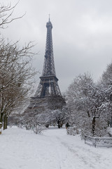 Fototapeta na wymiar Paris, France - February 7, 2018: Eiffel tower and champs de mars covered with snow