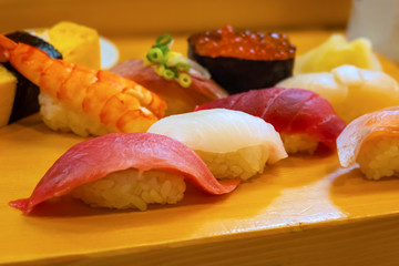 A set of japanese traditional sushi set  beautifully decorated on a wood plate