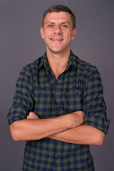 Handsome man with short hair against gray background