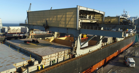 Drone pull-back of aluminum ingots being loaded onto a ship for export from Australia.