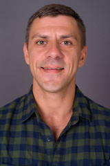 Fototapeta premium Handsome man with short hair against gray background