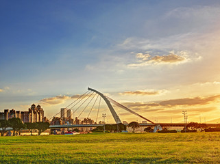 Beautiful morning light in public park with green grass field 