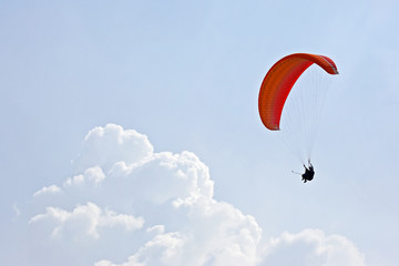 Paraglider flying on a wing in the sky