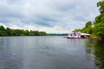 Fototapeta na wymiar Houses along Amazonas river. Brazilian panorama