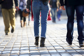 Fototapeta premium people cross the road at a pedestrian crossing on the pavement