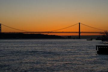 Sunset view of Tagus river (Rio Tajo) and 25th of April Bridge (Ponte 25 de Abril). Lisbon, Portugal
