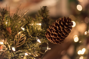 Holiday background with lights and pine cone