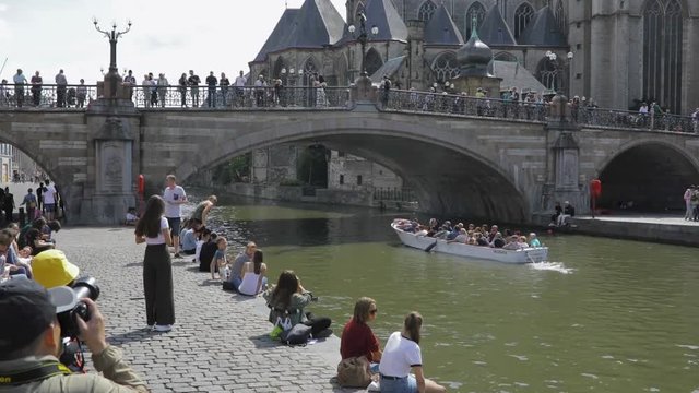 SLOW MOTION Tourists in the medieval center of Ghent, Belgium, enjoying the summer day.
